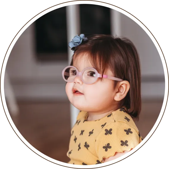 Child wearing prescription glasses for early vision correction