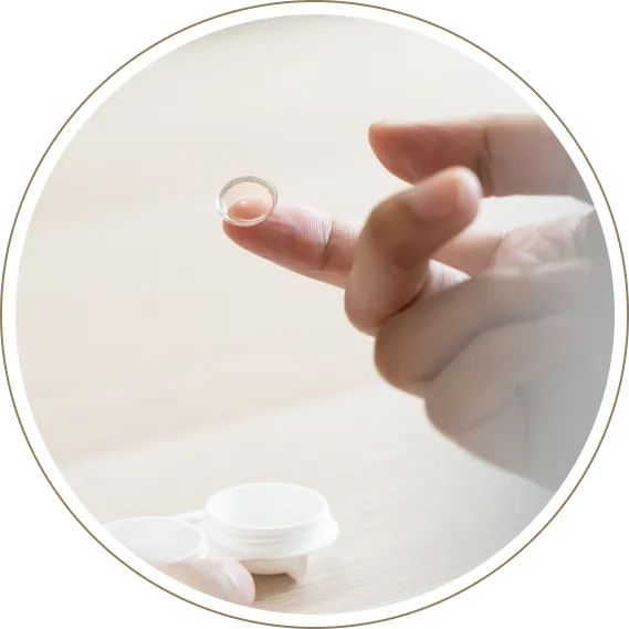 Contact lens resting on fingertip before vision correction use