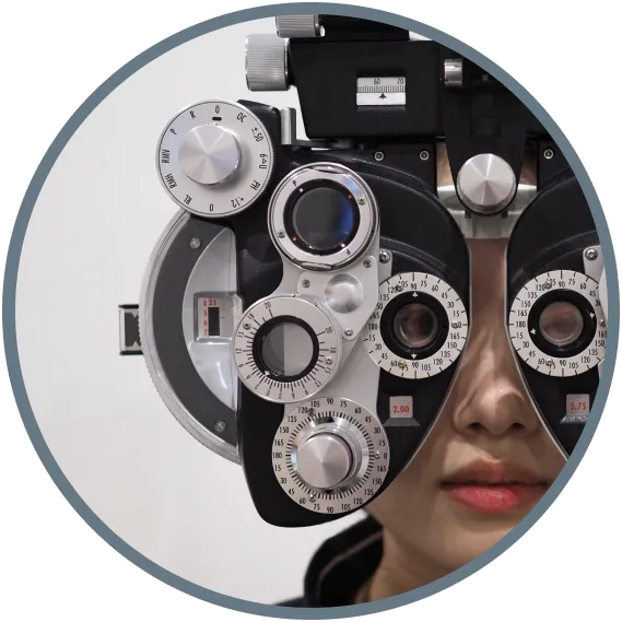 Patient undergoing phoropter vision test during eye exam