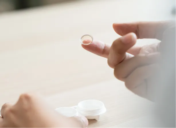 Contact lens resting on fingertip