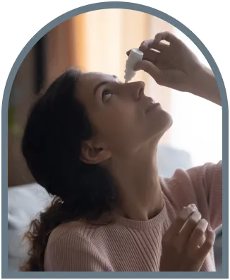 Woman applying eye drops at home for dry eye relief care use