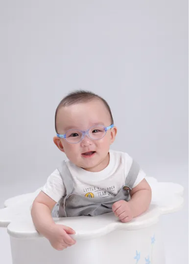 Infant wearing glasses during early vision development therapy