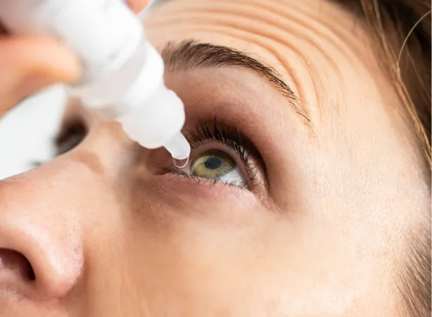 Person applying prescription eye drops